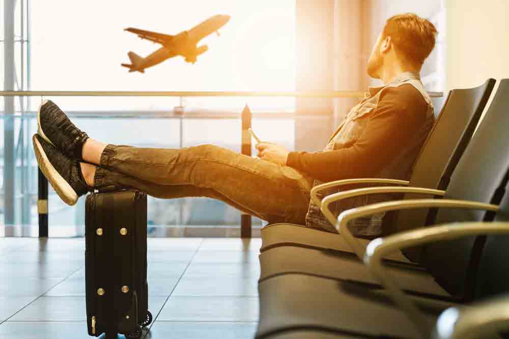 man-sitting-in-airport-lounge-sunset